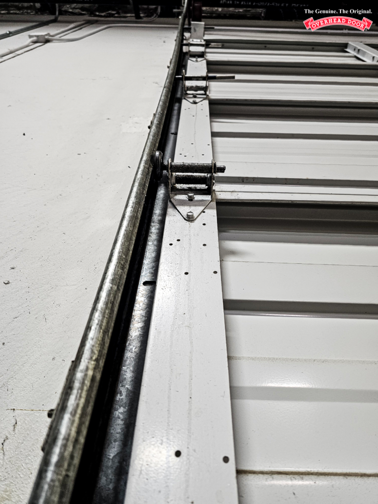 Side of a garage door showing garage door rollers